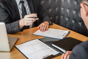 Job interview concept , Senior manager reading a resume during a job interview employee young man meeting Applicant and recruitment
