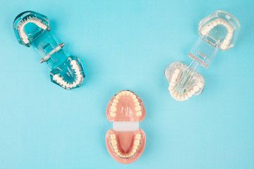 dentist tools and orthodontic on the  blue background, flat lay, top view.