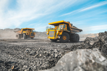 Large quarry dump truck. Loading the rock in dumper. Loading coal into body truck. Production...