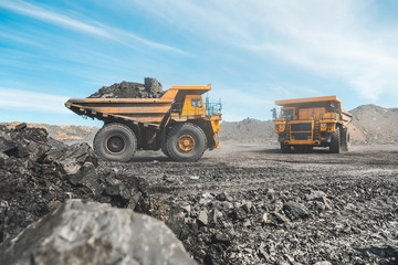 Large quarry dump truck. Loading the rock in dumper. Loading coal into body truck. Production...