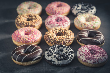 Obraz na płótnie Canvas Sweet and tasty donuts with different sprinkles