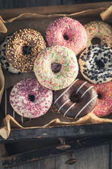 Sweet and tasty donuts in old wooden boxes