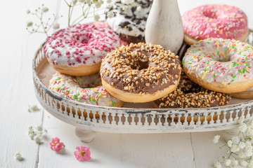 Delicious and sweet donuts on white wooden table