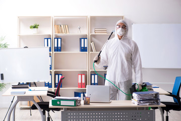 Professional contractor doing pest control at office 