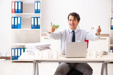 Young employee addicted to coffee