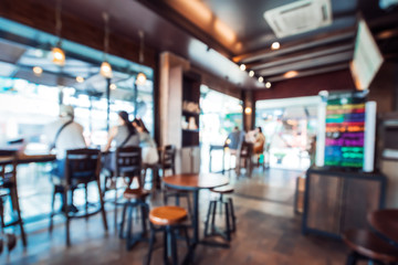 Blurred background image of coffee shop. abstract blur background with people in cafe. vintage color tone style - Powered by Adobe