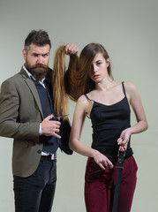 Professional hairstylist. Woman visiting hairstylist in hair salon. Long hair. Fashion haircut. Hairdresser, beauty salon.