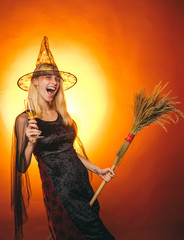 Indoor portrait of cute young witch at halloween party. Glamour Fashion Sexy Vampire Lady with...