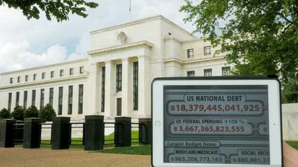a debt clock and the exterior of the federal reserve building - obrazy, fototapety, plakaty