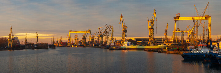 industrial areas of the shipyard in Szczecin in Poland,merchant ship in the dry dock of the repair yard,panorama with high resolution and detail