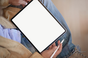 Top view of a man holding mockup blank screen digital tablet device