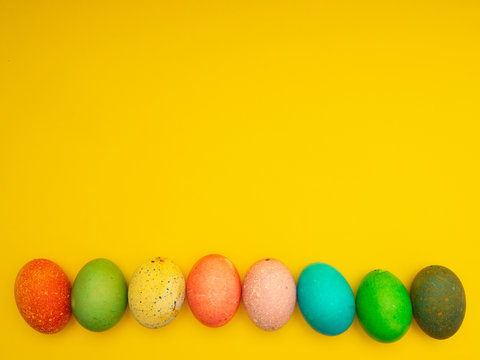 Colorful Easter Eggs On Yellow Background