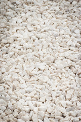 Footpath made of small white stones, background texture