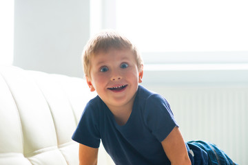 Portrait of happy smiling boy. Attractive kid at home.