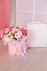 beautiful bouquet of spring flowers and white shopping bag