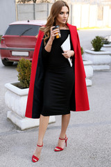 Fototapeta premium beautiful woman with dark hair in elegant outfit walking by the street