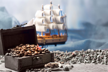 Image of middle-aged coffee beans. Poured into a pirate chest. Precious, expensive, tonic,...
