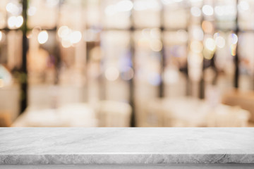 Empty white marble stone table top on blurred with bokeh cafe and restaurent interior background -...