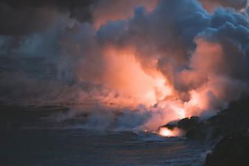 Big Island of Hawaii Volcano Lava and Magma spew into the pacific ocean with plumes of smoke and ash USA