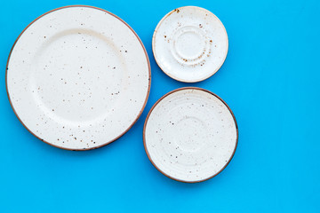 Mockup with plates. Empty ceramic plates on blue background top view copy space