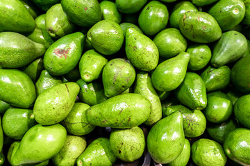 Fresh organic exotic green avocado on a local food market, Bali island. Avocado background.