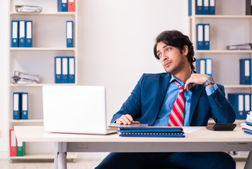 Young handsome businessman sitting in the office 