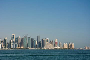 Fototapeta na wymiar Skyline of the commercial center of Doha with skyscrapers and waterfront