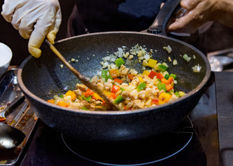 Chef cooking food in the kitchen, stir fried vegetables in the pan