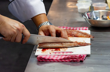 Chef cutting fish, Chef slices fish fresh on Board in the kitchen