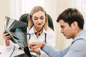 Fototapeta premium Female doctor looking at x-ray photo in hospital.healthcare and medicine
