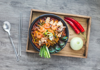 Fototapeta na wymiar Korean food, Jampong, spicy noodle seafood in black bowl for korean menu style.