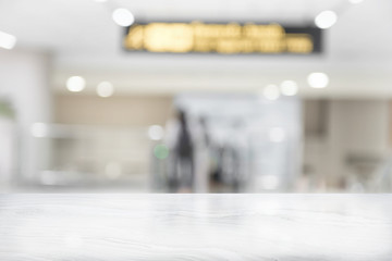 White marble table top on blur coffee shop