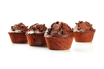 A side view of chocolate chip muffins on a white background with copy space