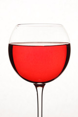 Bright red cocktail against white background