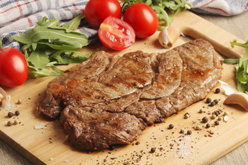 A beef steak well done with vegetables