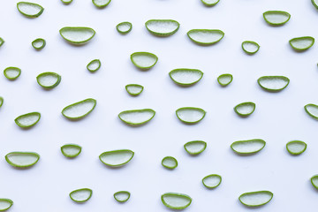 Aloe vera slices on white background.