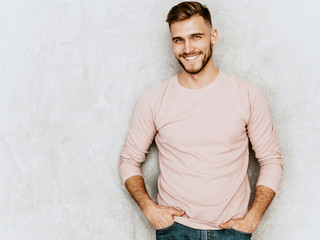 Portrait of handsome smiling hipster lumbersexual businessman model wearing casual summer pink...