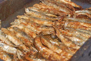freshly smelt fry on a baking tray in the open air