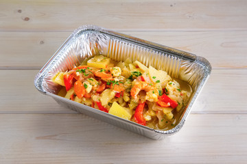 Shrimp stew with potato, paprika, carrot and onion in take away packing