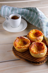 Pasteis de Nata, Portuguese Custard Tarts and ceramic cup of coffee