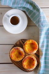 Pasteis de Nata, Portuguese Custard Tarts and ceramic cup of coffee