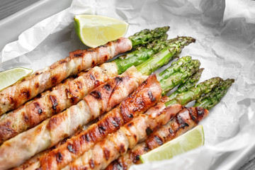 Bacon wrapped asparagus in baking dish, closeup