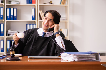 Young handsome judge working in court 