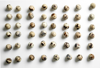 Raw quail eggs on white background