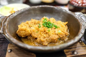 Crispy fried pork or Tonkatsu with miso sauce in the bowl. Japanese food.