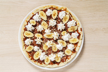 sweet pizza with chocolate paste and bananas