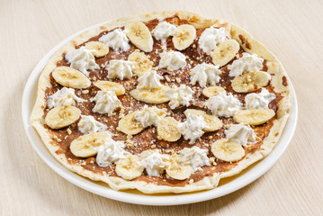 sweet pizza with chocolate paste and bananas