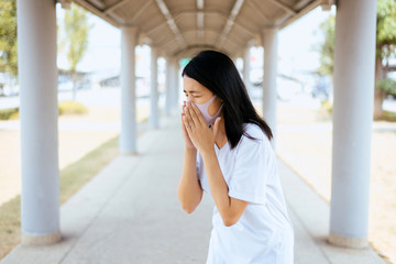 Asian woman using mask protect PM 2.5 because pollution in home,Young female got nose allergy