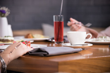 A table laid in a cafe, two girls at the table