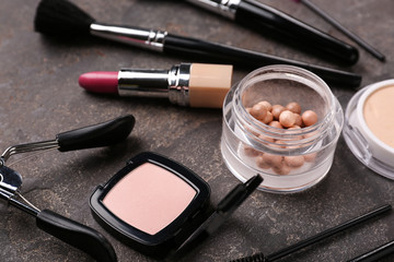 Professional makeup cosmetics with accessories on grey background
